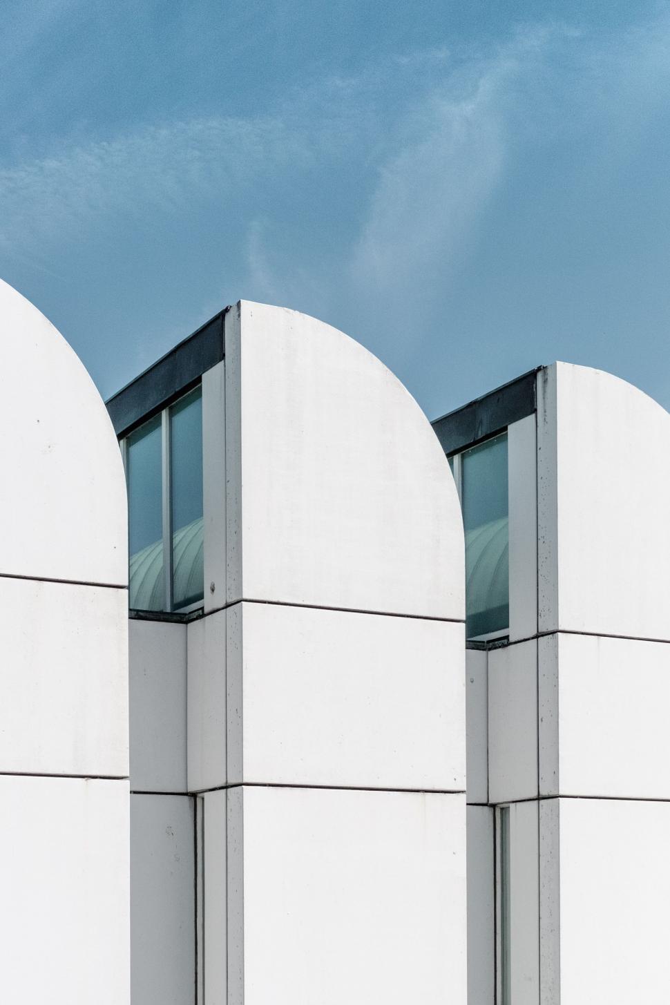 Free Image of Two Tall White Buildings Standing Side by Side 