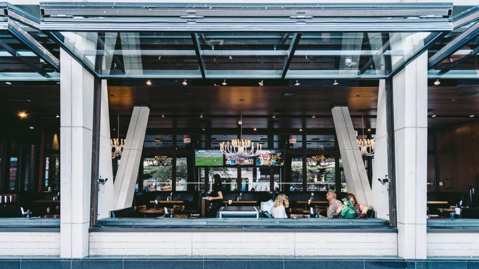 Free Image of Two People Sitting at a Table in a Restaurant 
