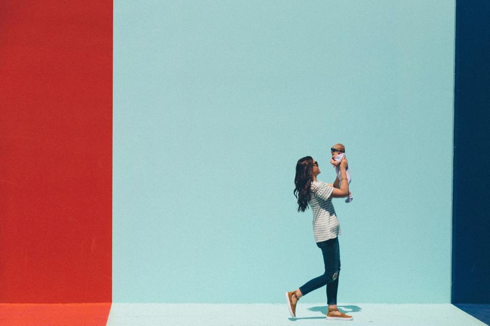 Free Image of Woman Holding Baby in Arms 