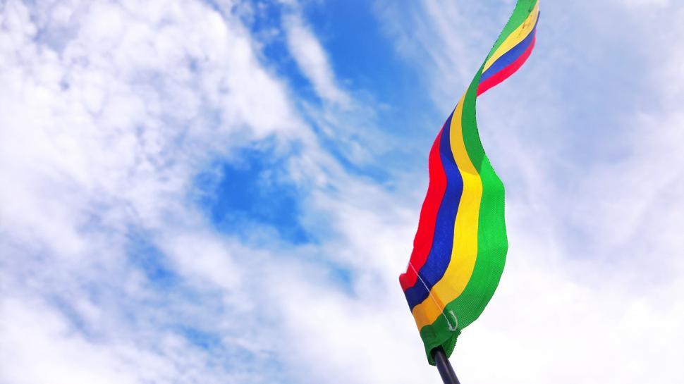 Free Image of Rainbow Colored Kite Flying in the Sky 