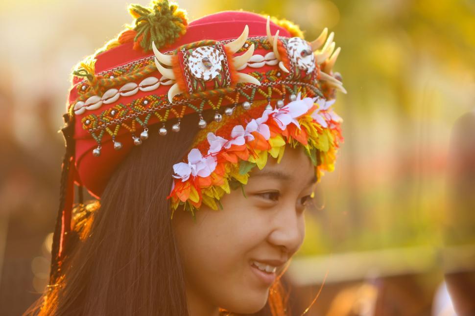 Free Image of Woman Wearing Red Hat With Flowers 