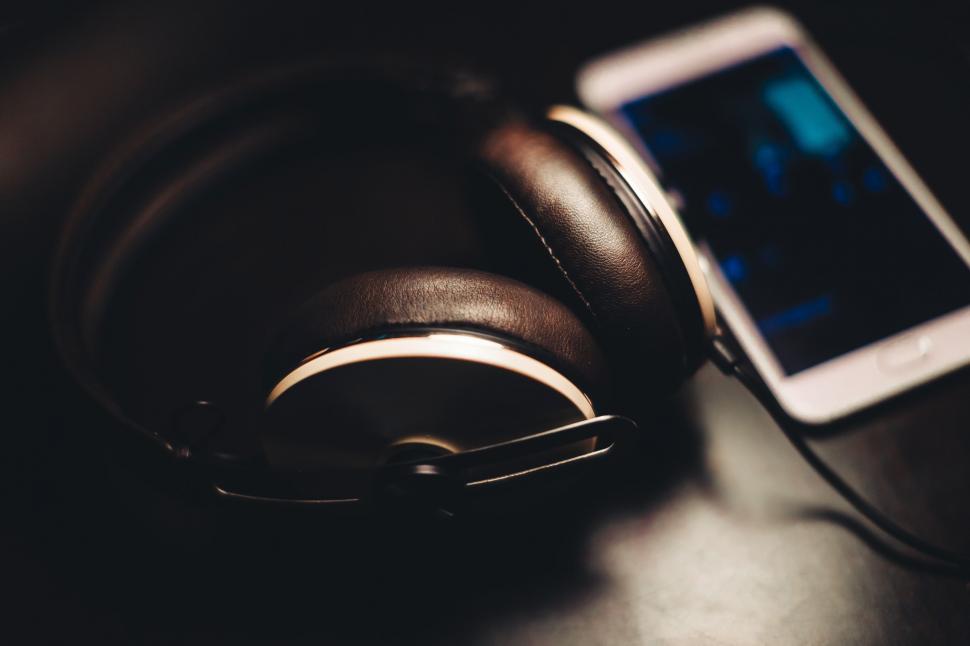 Free Image of Cell Phone and Headphones on Table 