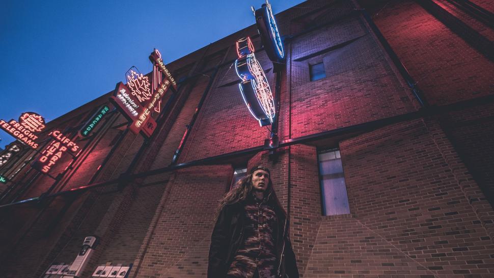 Free Image of Man Standing in Front of Building 