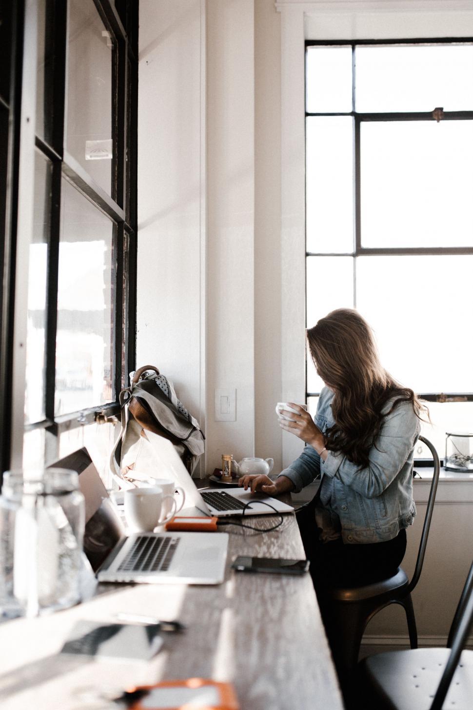 Free Image of Woman Sitting at Table With Laptop 