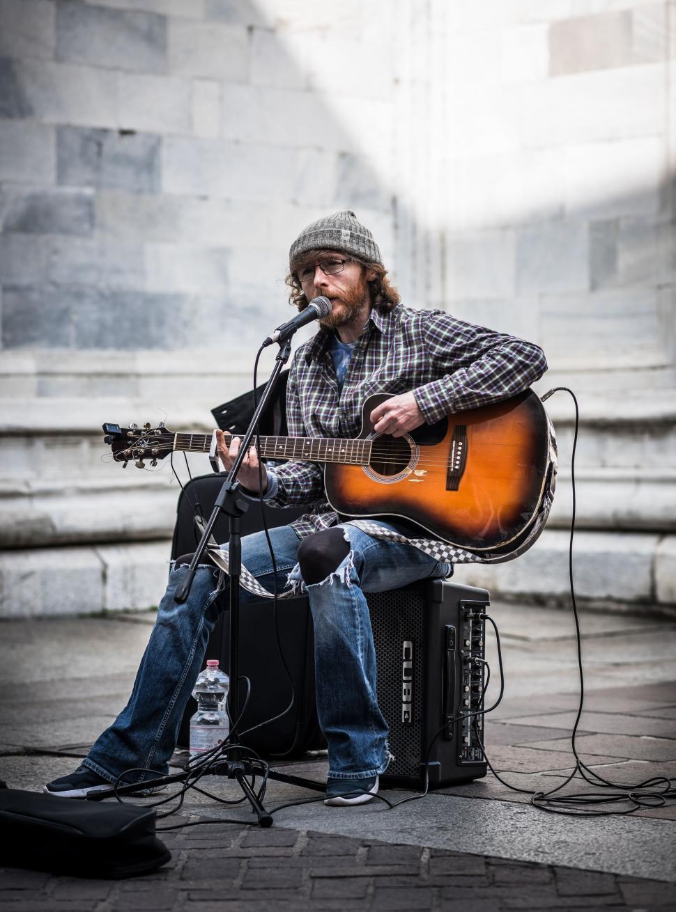 Free Image of Man Playing Guitar and Singing Into Microphone 