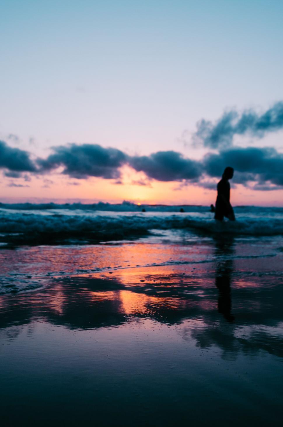 Free Image of Person Walking on Beach at Sunset 