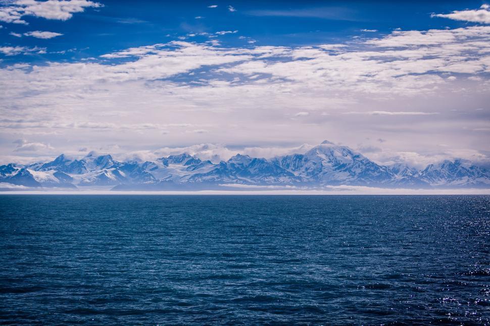 Free Image of Majestic Mountain Range Overlooks Vast Body of Water 