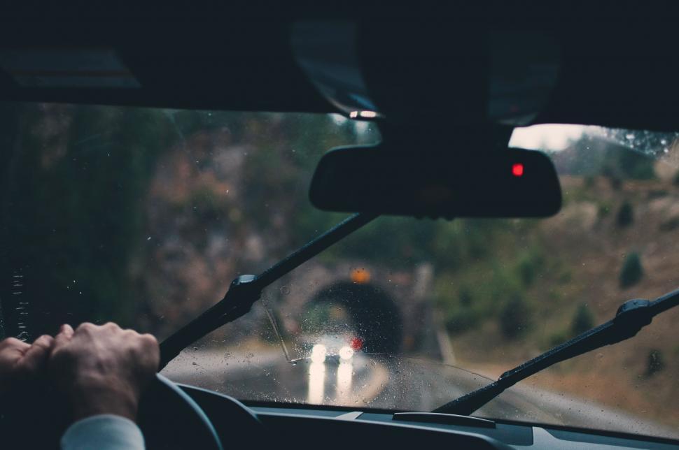 Free Image of Man Driving a Car Down a Road 