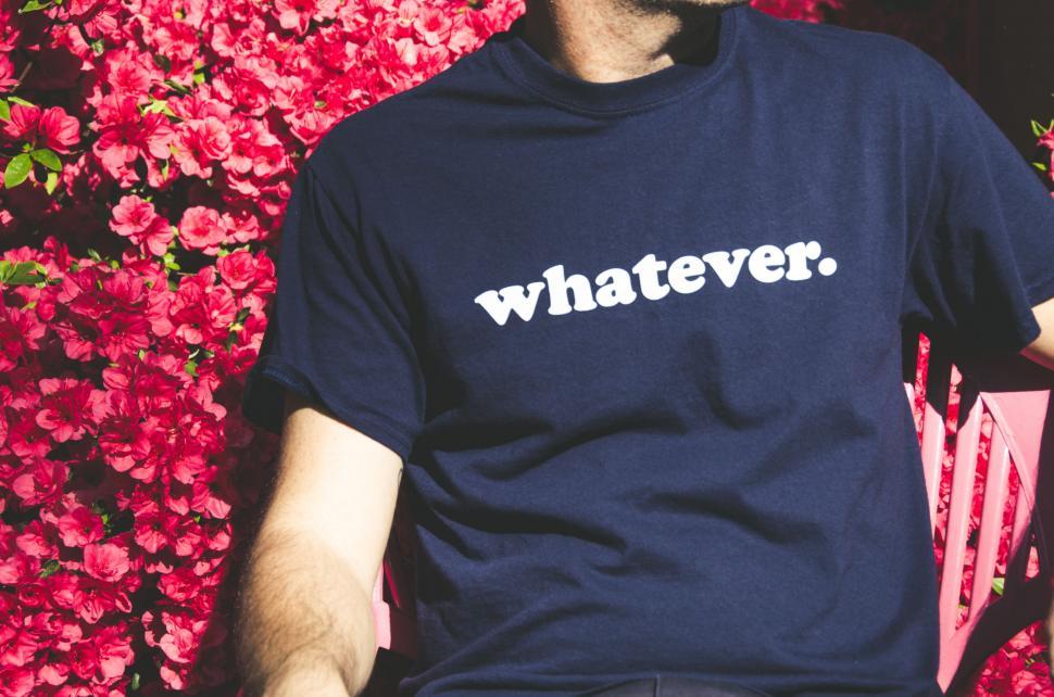 Free Image of Man Sitting on Bench in Front of Flowers 
