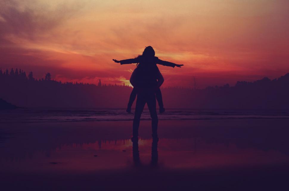Free Image of Person Standing on Beach at Sunset 