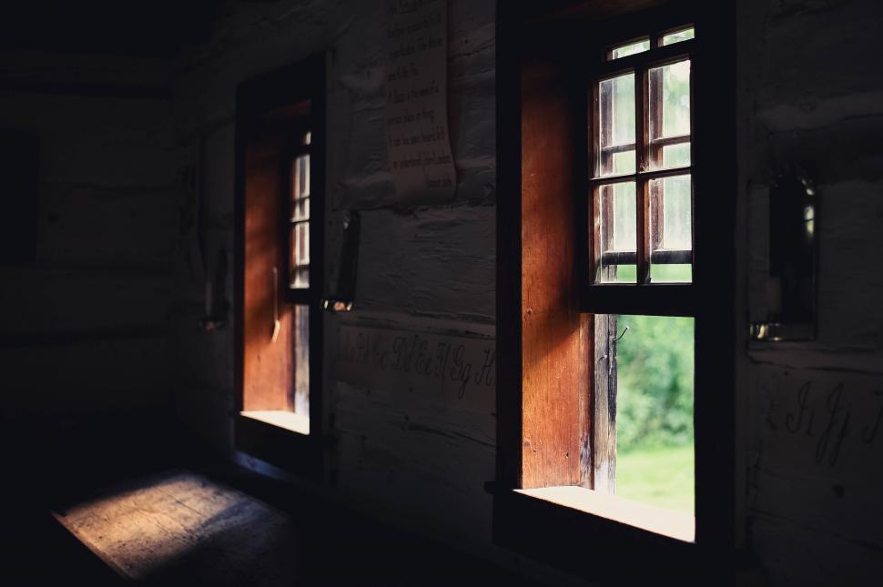 Free Image of Dark Room With Three Windows and Light 
