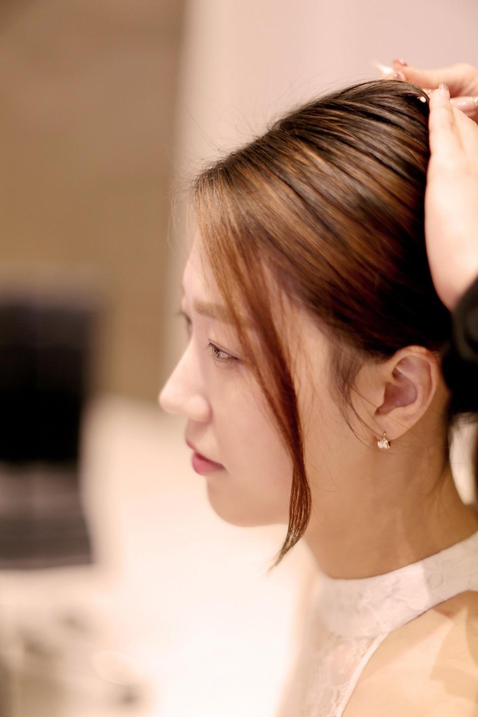Free Image of Woman Getting Hair Styled by Hair Stylist 