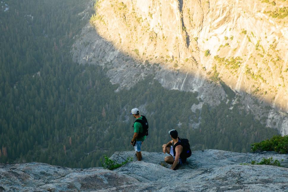 Free Image of Couple Sitting on Top of a Mountain 