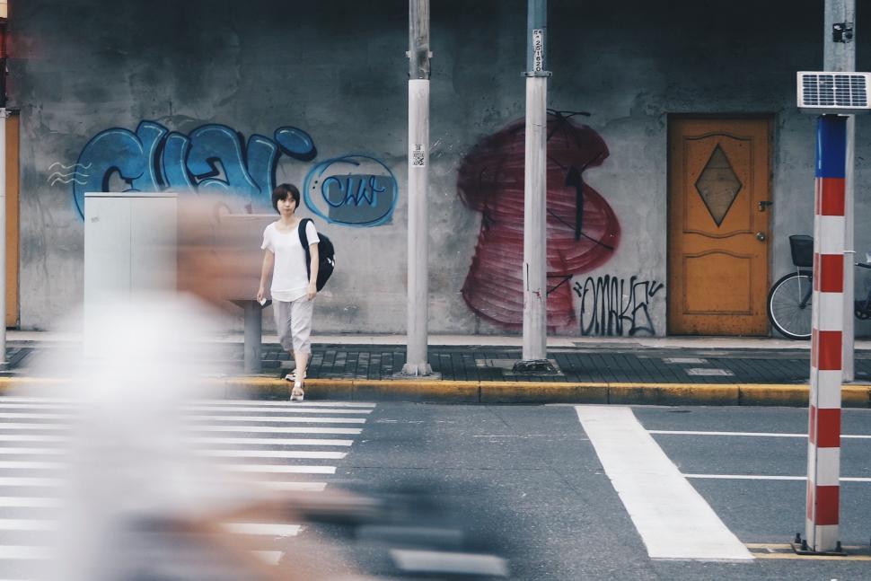 Free Image of Man Walking Across Street Next to Crosswalk 