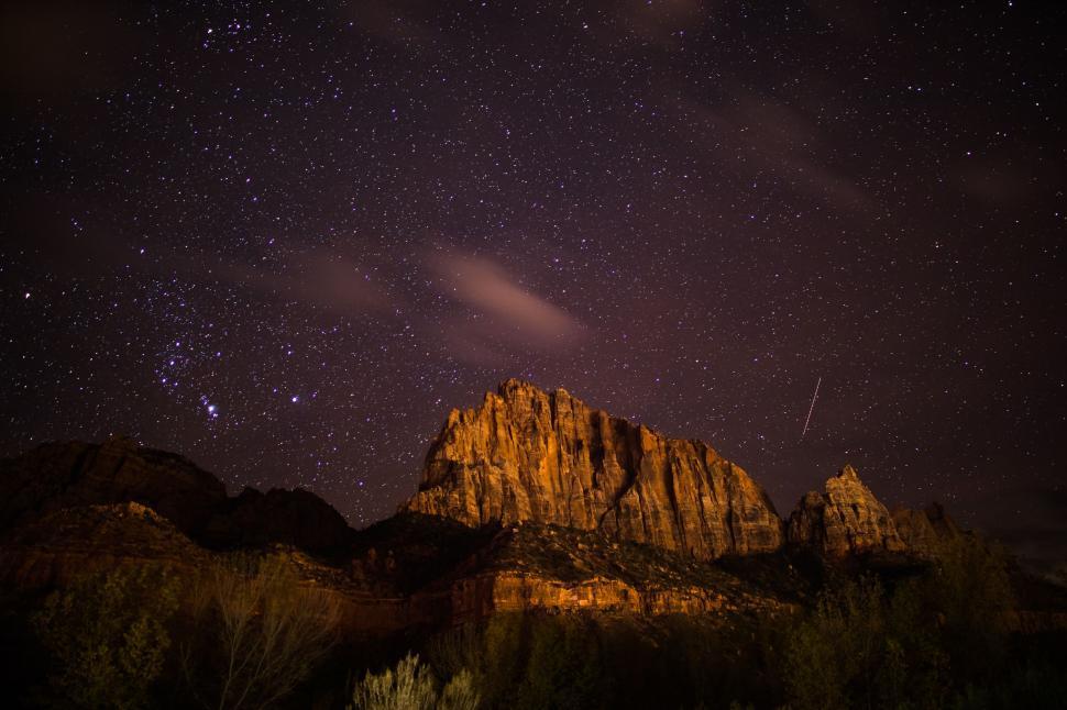 Free Image of Starry Night Sky Above Mountain Peak 
