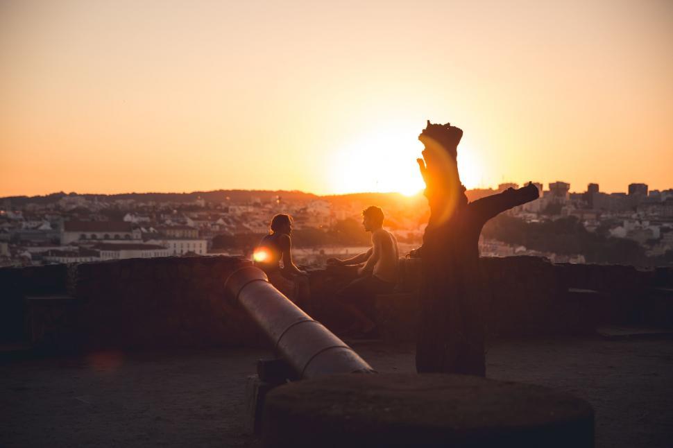 Free Image of Person Sitting on Bench Watching Sunset 