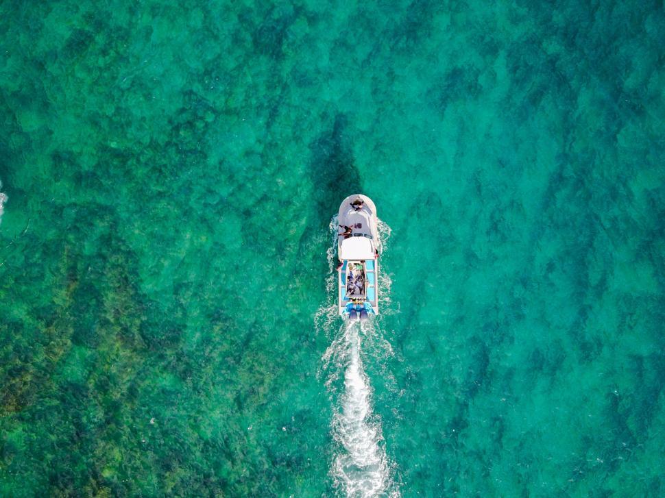 Free Image of Boat Traveling in Clear Blue Water 