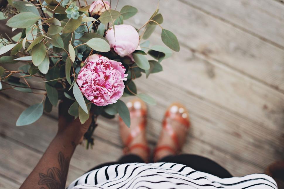 Free Image of Person Holding Bouquet of Flowers on Wooden Floor 