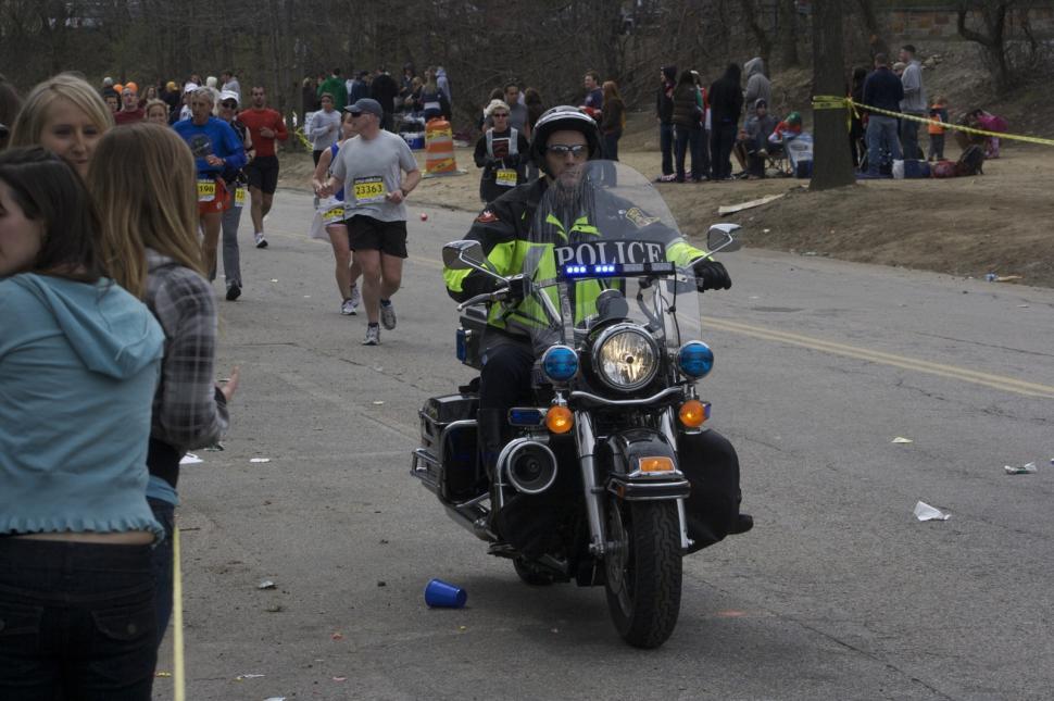 Free Image of Police Officer Riding on the Back of a Motorcycle 
