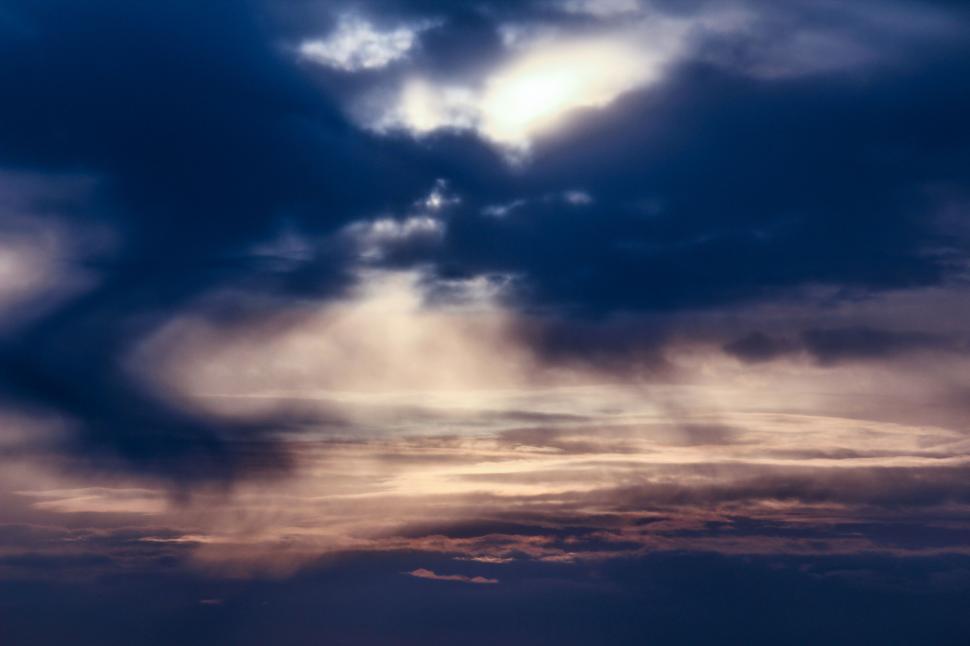 Free Image of A Plane Flying in the Sky With Clouds 