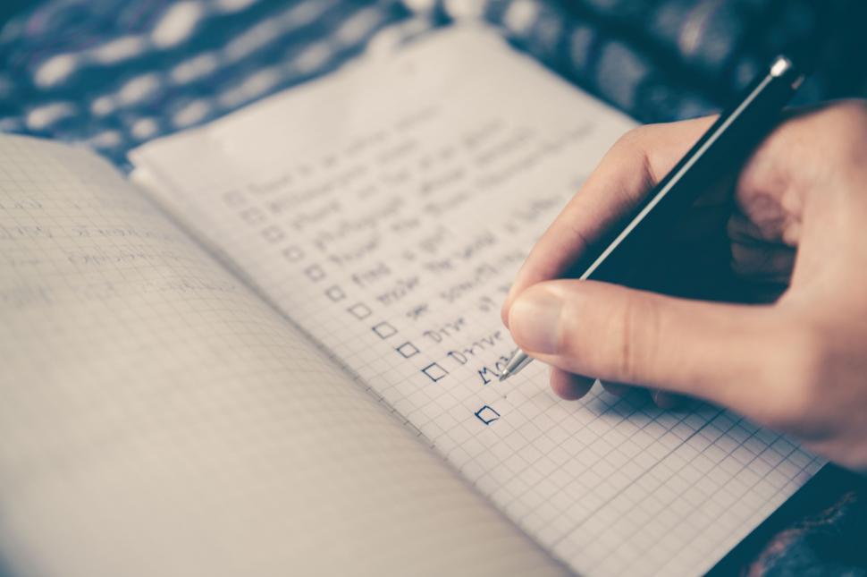 Free Image of Person Writing on a Notebook With a Pen 