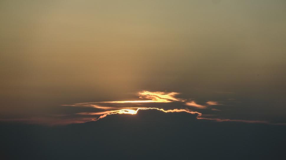 Free Image of Sun Shining Through Clouds in Sky 