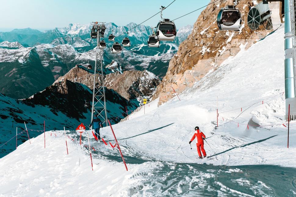 Free Image of Person in Red Suit Skiing Down Mountain 