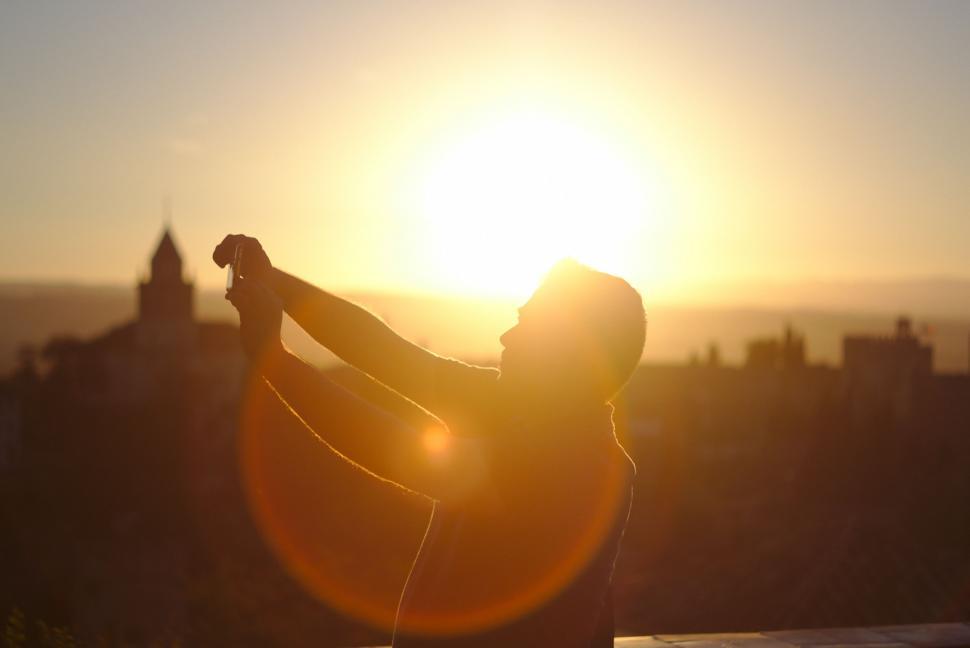Free Image of Woman Standing on Roof Next to the Sun 
