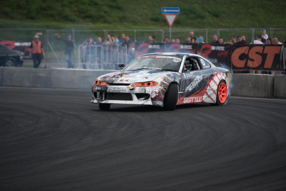 Free Image of Car Racing Around Track With Smoke 