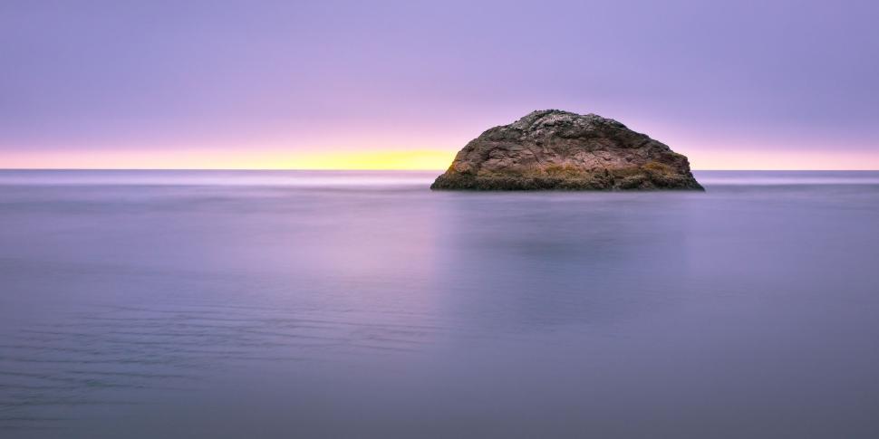 Free Image of Rock in the Middle of a Body of Water 