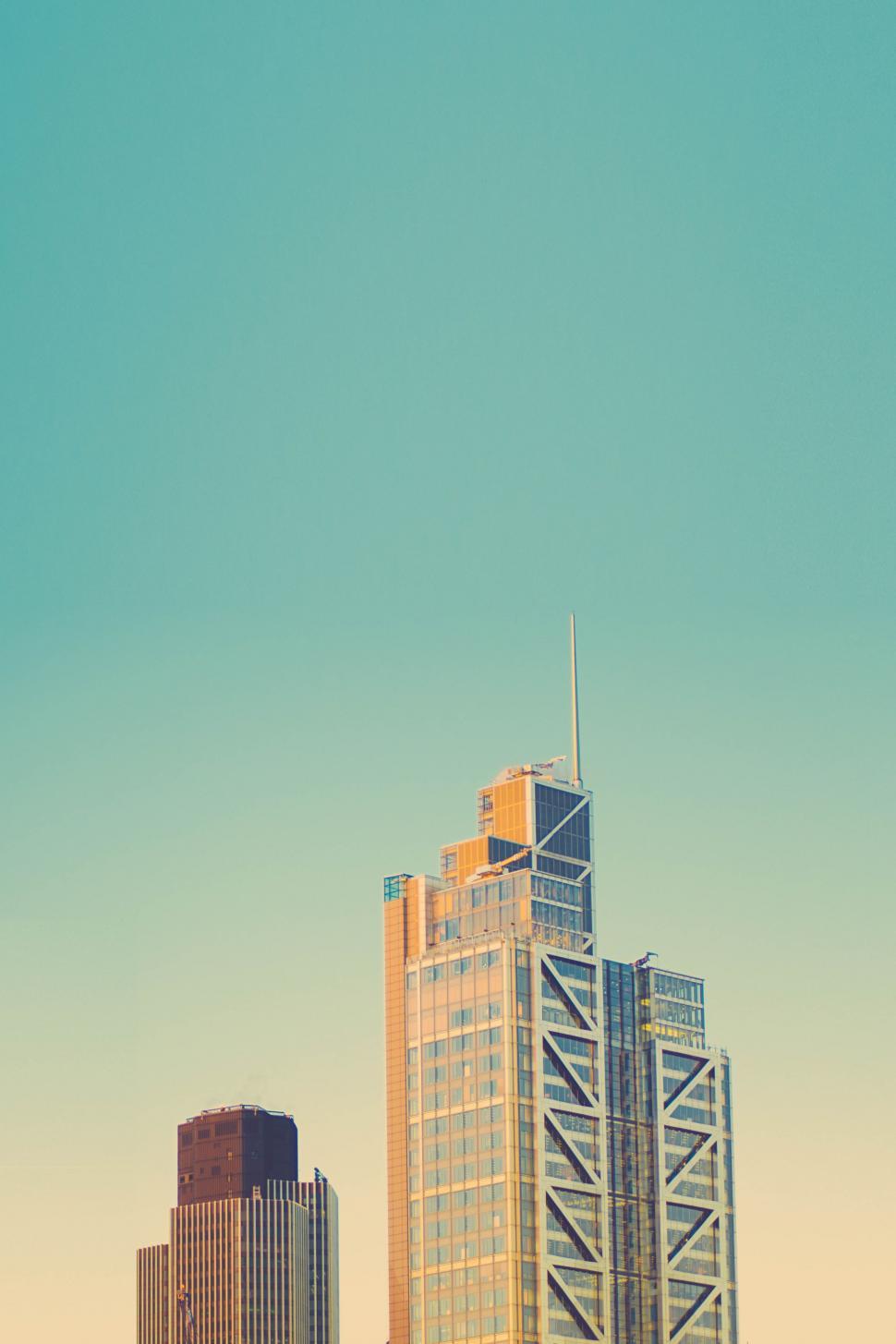 Free Image of Cityscape With Tall Buildings and Plane Flying 