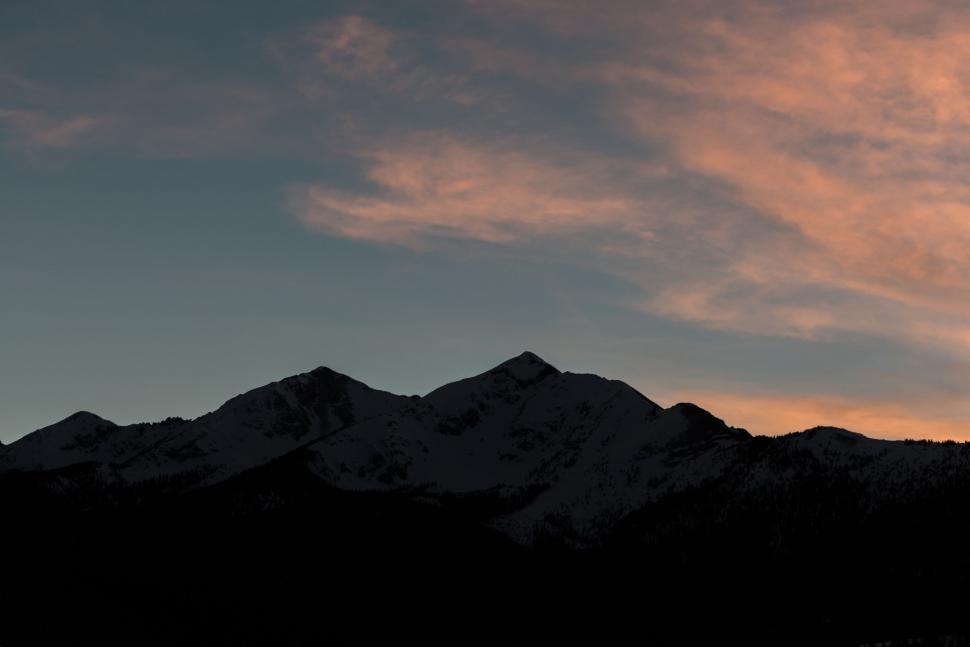 Free Image of Majestic Silhouette of Mountain Range Against Cloudy Sky 