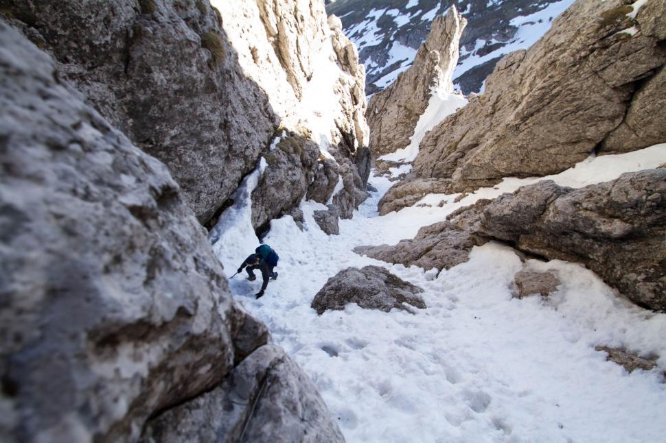 Free Image of Man Climbing Up Snow Covered Mountain 