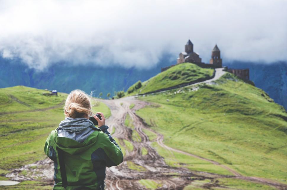 Free Image of Woman Capturing Castle on Hill 
