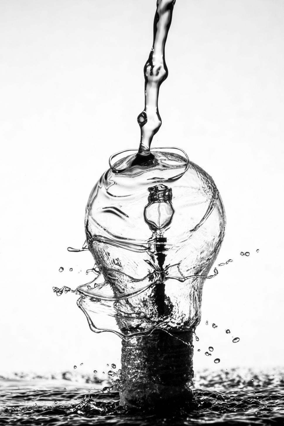 Free Image of Water Bottle Pouring Water Into River 