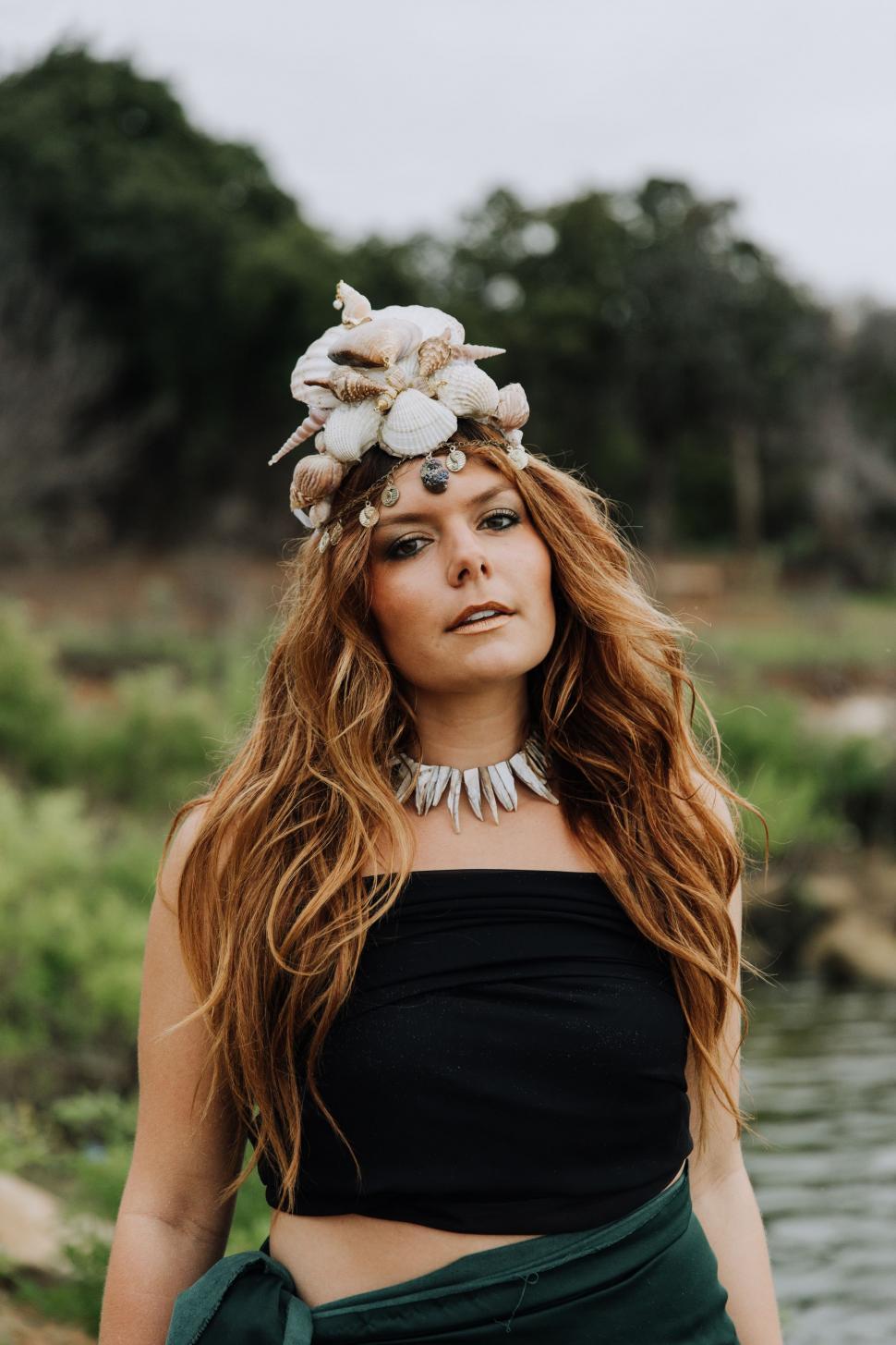Free Image of Woman With Long Red Hair Wearing a Black Top 