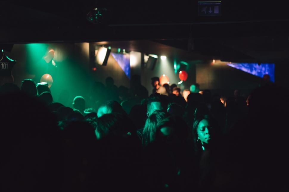 Free Image of Group of People Standing in Dark Room 