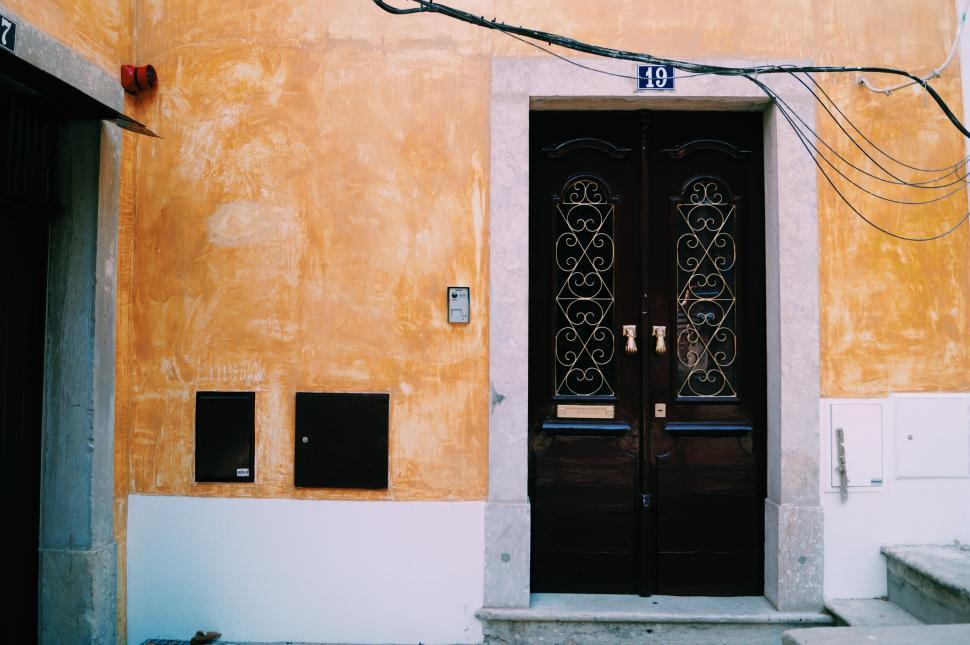 Free Image of Black Door on Yellow Building 