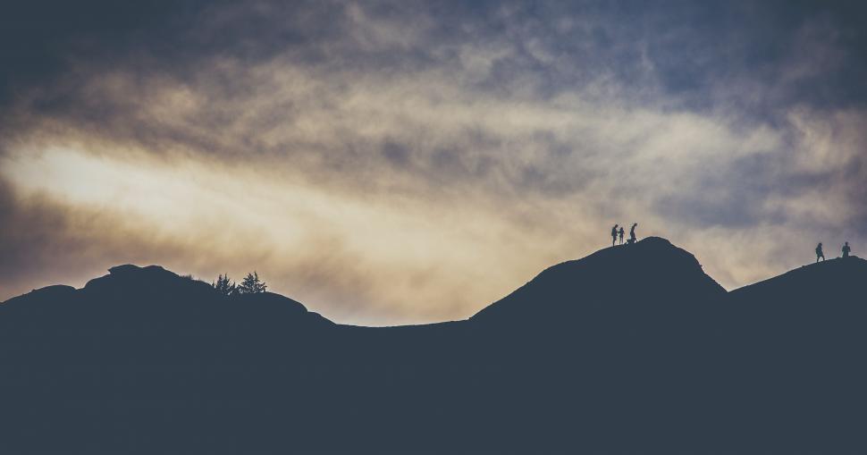Free Image of Group of People Standing on Top of a Mountain 