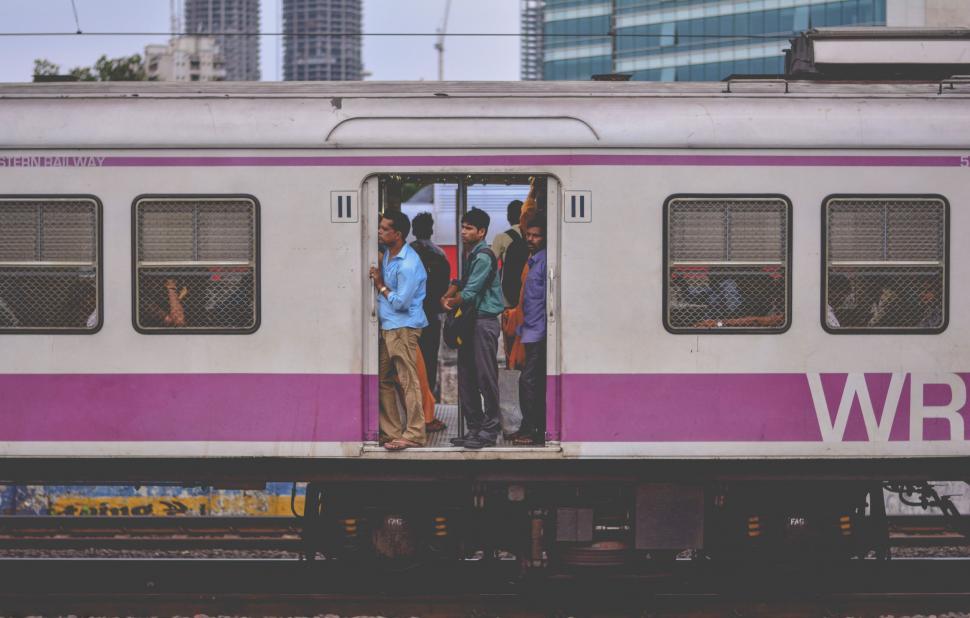 Free Image of Group of People Standing on the Door of a Train 