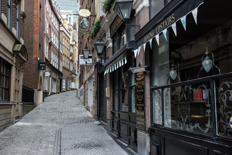 Free Image of Urban Canyon: Tall Buildings Hemming a Narrow City Street 