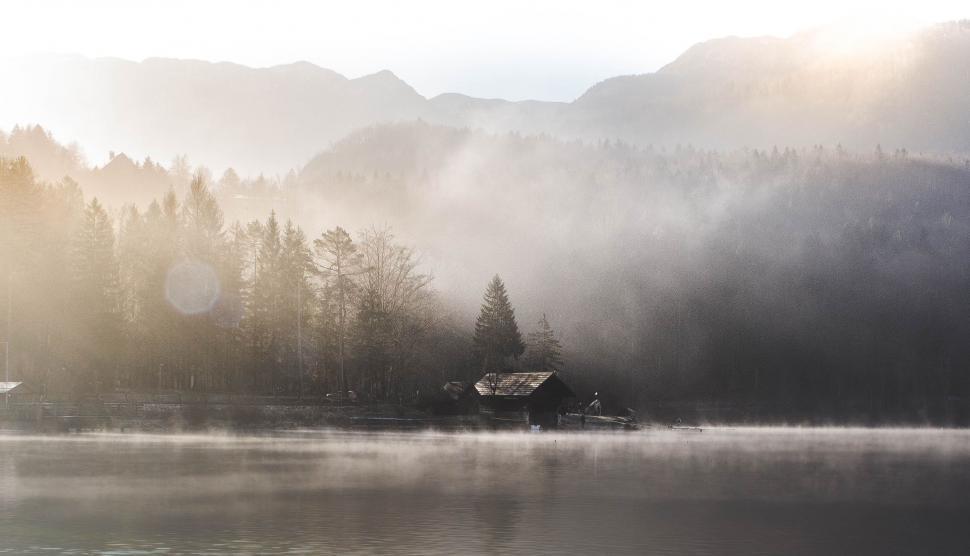 Free Image of Boat Sailing in Lake Surrounded by Mountains 