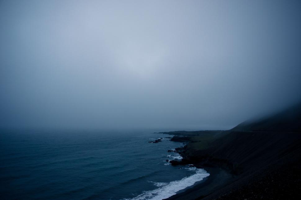 Free Image of Misty Sky Above Vast Water Body 