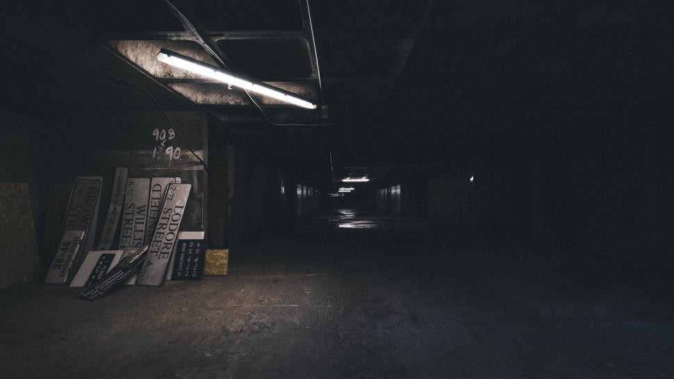 Free Image of Dimly Lit Hallway With Books Scattered on Floor 