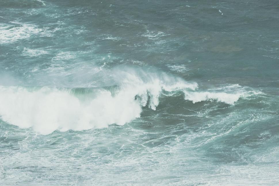 Free Image of Man Riding Wave on Surfboard 