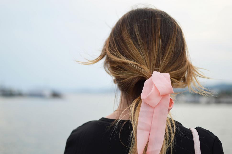 Free Image of Woman Wearing Pink Bow in Hair 