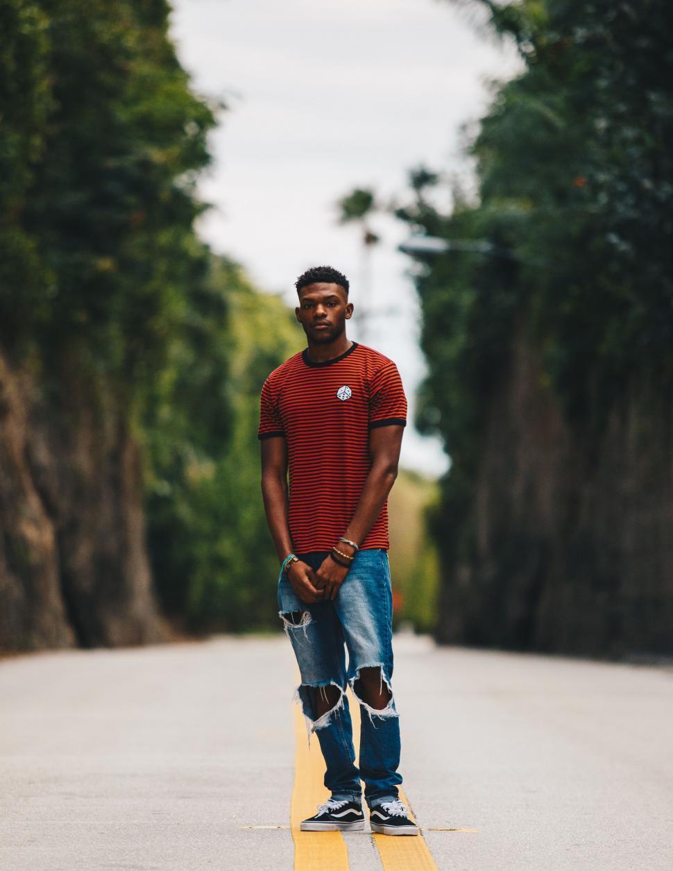 Free Image of Man Standing on Skateboard on Road 