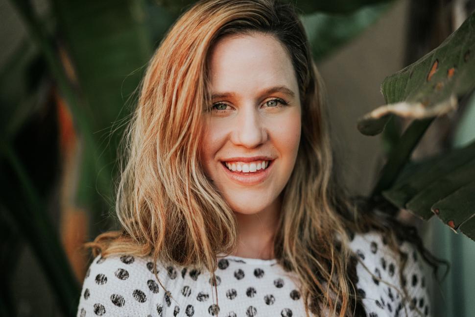 Free Image of Woman With Long Hair Smiling at the Camera 