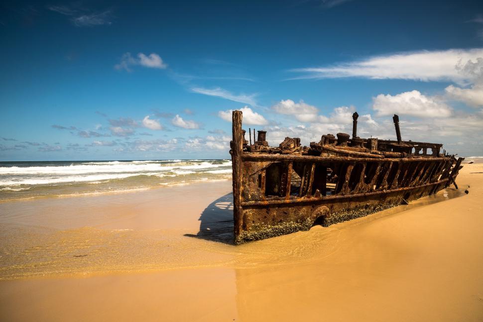 Free Image of Old Ship Resting on Sandy Beach 