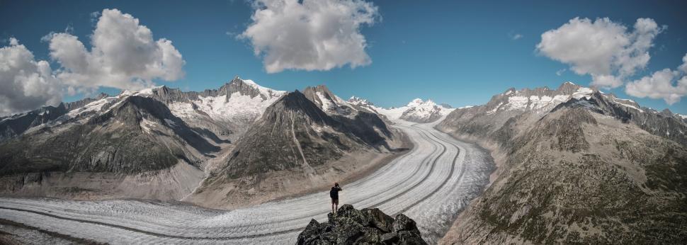 Free Image of Man Standing on Top of Snow Covered Mountain 
